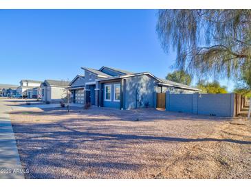 Single-story home with gray exterior, two-car garage, and desert landscaping at 2508 N Franz Ln, Casa Grande, AZ 85122