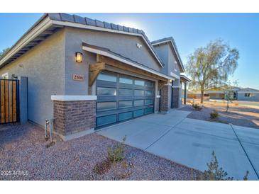 Two-car garage with modern door and brick accents at 2508 N Franz Ln, Casa Grande, AZ 85122