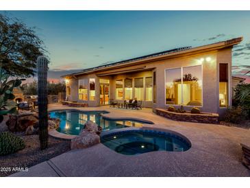 Inviting backyard oasis with sparkling pool, spa, and desert landscaping at 32032 N 52Nd Way, Cave Creek, AZ 85331