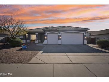 Gray house with two-car garage and landscaped front yard at 3519 E Red Oak Ln, Gilbert, AZ 85297