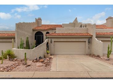 Tan stucco exterior boasts a two-car garage and desert landscaping at 6168 S Fairway Pl, Gold Canyon, AZ 85118