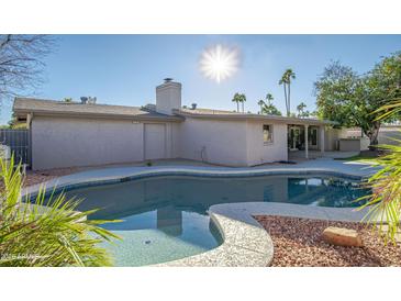 Inviting kidney-shaped pool with a spa, surrounded by rock landscaping at 6630 E Dreyfus Ave, Scottsdale, AZ 85254