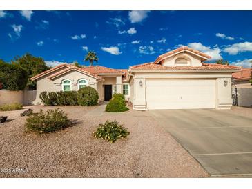 Single-story home with a two-car garage and desert landscaping at 10428 E Hercules Dr, Sun Lakes, AZ 85248