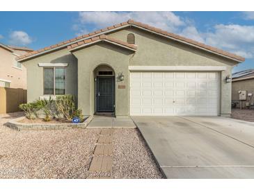 One-story house with a two-car garage and desert landscaping at 17332 W Jefferson St, Goodyear, AZ 85338