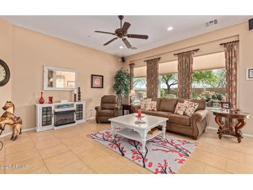 Spacious living room featuring a comfortable couch and large windows at 28175 N 123Rd Ln, Peoria, AZ 85383