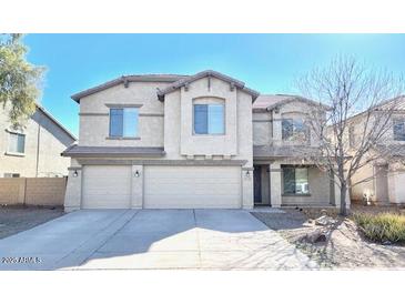 Two-story home with three-car garage and desert landscaping at 43439 W Magnolia Rd, Maricopa, AZ 85138