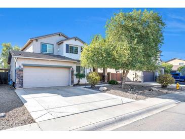 Two-story house with a large front yard, driveway, and attached garage at 10335 E Aster Ln, Florence, AZ 85132