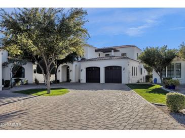 Two-story home with stucco exterior, two-car garage, and manicured landscaping at 1777 W Ocotillo Rd # 23, Chandler, AZ 85248