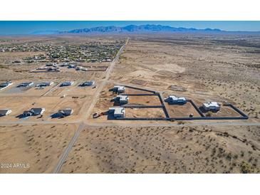 Aerial view of new homes and lots in a desert community at 23197 W Skinner Rd, Wittmann, AZ 85361