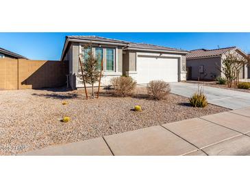 Single-story home with a white garage door and well-maintained landscaping at 308 E Hawaii Dr, Casa Grande, AZ 85122