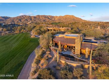 Luxury home with pool, golf course views, and mountain backdrop at 40980 N 97Th St, Scottsdale, AZ 85262