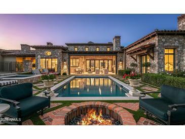 Luxury home with inviting pool, fire pit, and spacious patio at 42638 N Chiricahua Pass, Scottsdale, AZ 85262