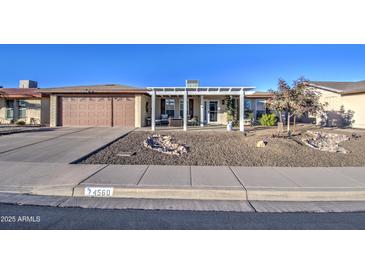 Ranch style home with carport and landscaped yard at 4560 E Dolphin Ave, Mesa, AZ 85206