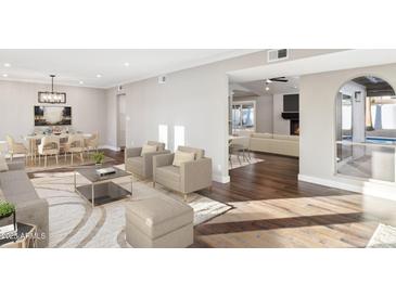 Spacious living area with hardwood floors, plush seating, and views to dining area at 9412 N 33Rd Way, Phoenix, AZ 85028