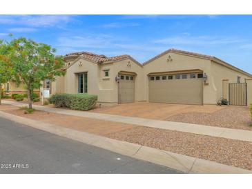 Exterior shot of home showing large garage, desert landscaping, and brown stone driveway at 10550 E Sanger Ave, Mesa, AZ 85212