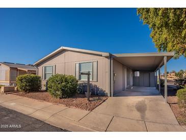 Single-wide manufactured home with carport and landscaping at 11275 N 99Th Ave # 188, Peoria, AZ 85345