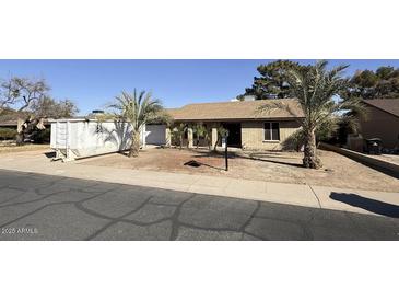 Ranch style home with mature landscaping and a spacious front yard at 14017 N 40Th Ave, Phoenix, AZ 85053