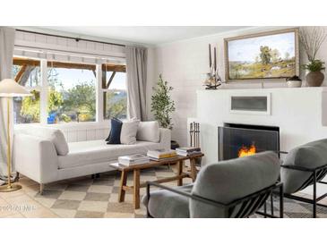 Cozy living room features a fireplace and comfortable seating at 1432 E Lupine Ave, Phoenix, AZ 85020