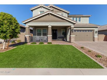 Two-story house with a green lawn, two-car garage, and front porch at 15130 W Linden St, Goodyear, AZ 85338