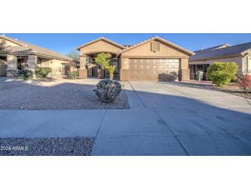 Single-story house with a two-car garage and desert landscaping at 1633 S 171St Dr, Goodyear, AZ 85338