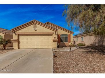 Charming single-story home showcasing a well-maintained front yard and attached two-car garage at 2172 W Pinkley Ave, Coolidge, AZ 85128