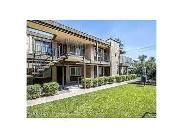 Well-maintained apartment building with lush landscaping and balconies at 2228 E Campbell E Ave # 234, Phoenix, AZ 85016