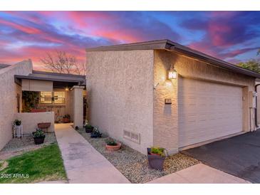 Attractive stucco home with a path, landscaping, and attached garage at 2256 W Lindner Ave # 25, Mesa, AZ 85202