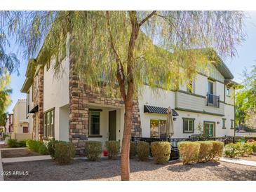 Two-story townhome with stone accents and a patio at 2780 S Equestrian Dr # 102, Gilbert, AZ 85295