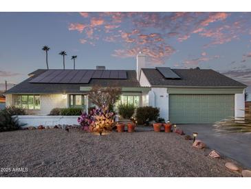 White single story home with solar panels and landscaping at 3036 W Gail Rd, Phoenix, AZ 85029