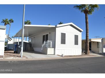 Charming single-story home with covered parking and manicured landscaping at 7807 E Main St # F36, Mesa, AZ 85207