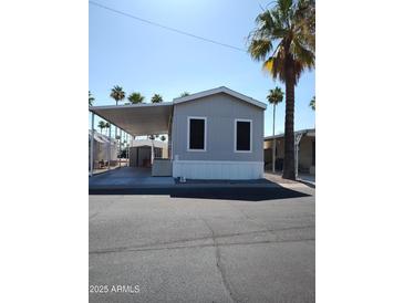 Gray manufactured home with carport and desert landscaping at 7807 E Main St # Ofc, Mesa, AZ 85207