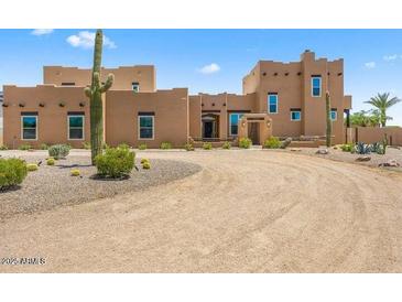 Stunning Southwestern-style home with a large front yard and desert landscaping at 9255 W Buckskin Trl, Peoria, AZ 85383