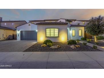 Stunning two-story home with a three-car garage and landscaped front yard at 9430 W Jj Ranch Rd, Peoria, AZ 85383