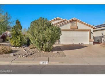House exterior featuring a two-car garage and well-maintained landscaping at 10634 W Mohawk Ln, Peoria, AZ 85382