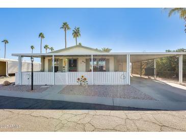 Inviting manufactured home with covered carport and landscaped yard at 120 N Val Vista Dr # 186, Mesa, AZ 85213