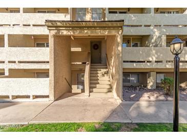 Building exterior with walkway and stairs leading to apartment entrance at 1331 W Baseline Rd # 251, Mesa, AZ 85202