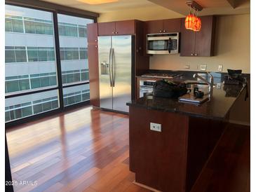 Modern kitchen with stainless steel appliances and granite countertops at 4808 N 24Th St # 824, Phoenix, AZ 85016