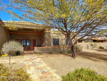 One-story home with stucco exterior, gated entry, and landscaped yard at 10400 E Breathless Ave, Gold Canyon, AZ 85118