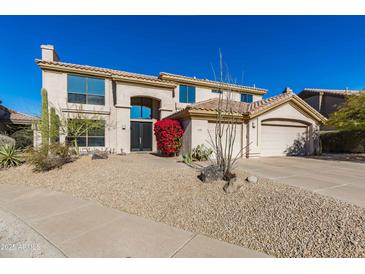 Two-story house with desert landscaping and a three-car garage at 12312 E Poinsettia Dr, Scottsdale, AZ 85259