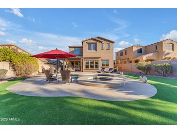 Stunning backyard oasis with a pool, spa, and patio area, perfect for entertaining at 13428 S 186Th Ave, Goodyear, AZ 85338