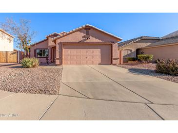 One-story house with a two-car garage and desert landscaping at 14749 N 153Rd Dr, Surprise, AZ 85379