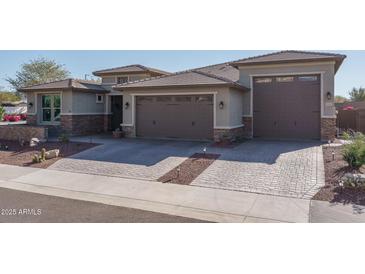 Beautiful two-story home with a three-car garage and landscaped front yard at 18147 W Sandy Rd, Goodyear, AZ 85338