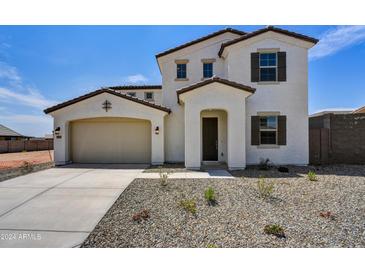 Two-story house with tan exterior, and a two-car garage at 19339 W Valle Vista Way, Litchfield Park, AZ 85340