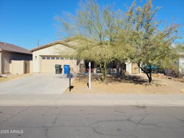 One-story house with tan exterior, two-car garage, and desert landscaping at 2416 E Wier Ave, Phoenix, AZ 85040