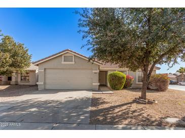 Single-story home with attached garage and well-manicured landscaping at 2605 S 80Th Ave, Phoenix, AZ 85043