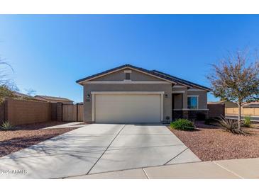 Single-story home with attached garage and landscaped front yard at 3189 N Excursion Ln, Casa Grande, AZ 85122