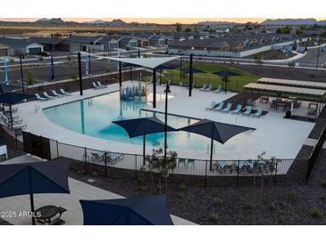 Community pool with a splash pad, lounging areas, and grills at 3201 E Hayden Rose Ave, San Tan Valley, AZ 85143