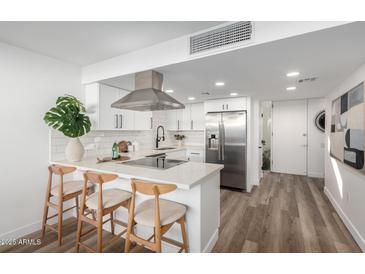 Modern kitchen with stainless steel appliances and white shaker cabinets at 4411 N 40Th St # 52, Phoenix, AZ 85018