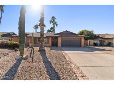 Brick house with a two-car garage and desert landscaping at 5109 E Blanche Dr, Scottsdale, AZ 85254