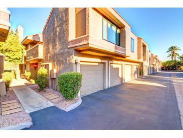 Exterior view of condo building, showing building facade and parking area at 5122 E Shea Blvd # 1029, Scottsdale, AZ 85254